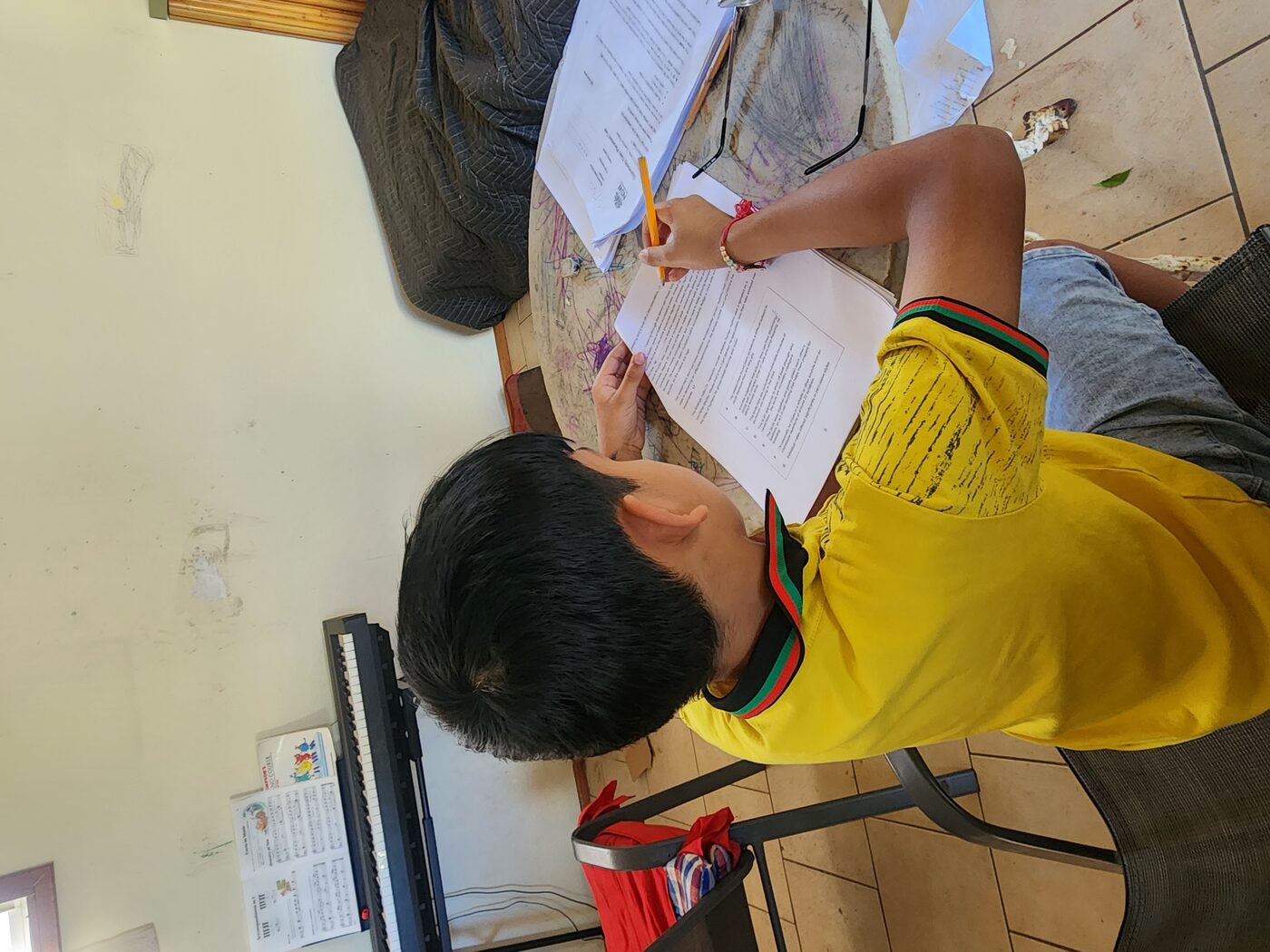 A student working through an exam-prep worksheet at home